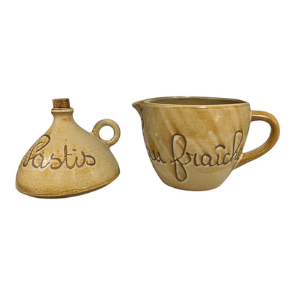 Two ceramic containers with embossed text on a white background