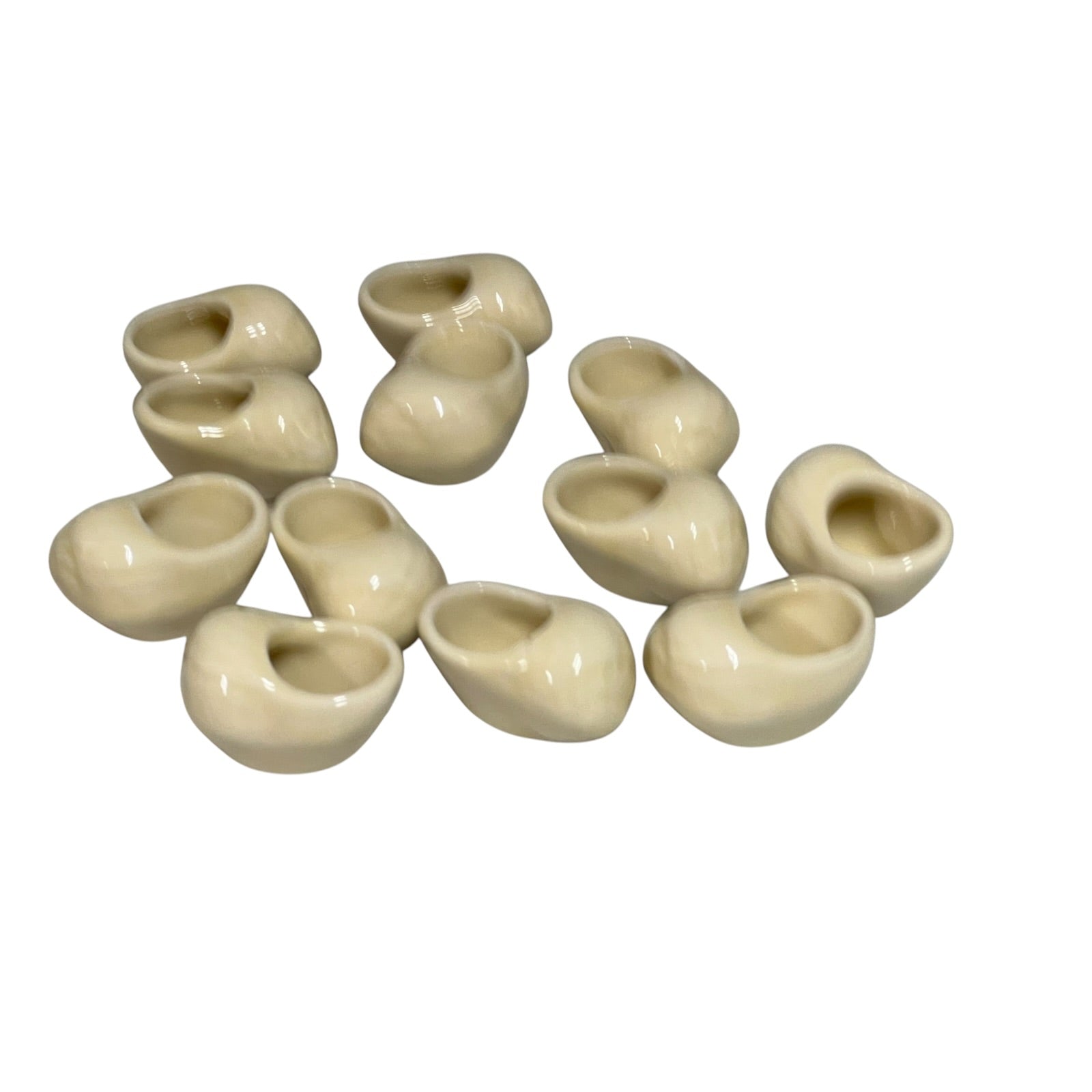 Set of 12 ceramic French escargot cups shaped like snails ideal for a restaurant or a keen French cook, set on a white background