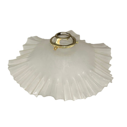 White glass lamp shade with gold metal fixture on a white background