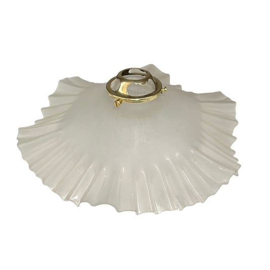 White glass lamp shade with gold metal fixture on a white background
