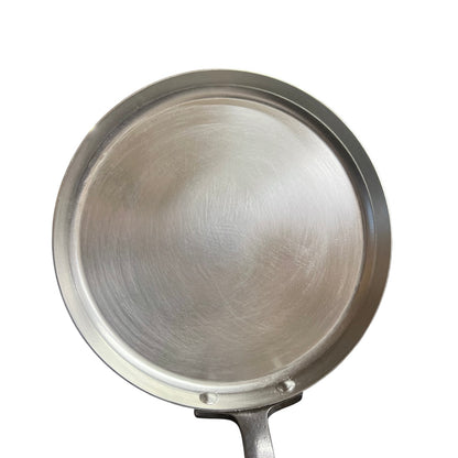 Metallic frying pan on a white background