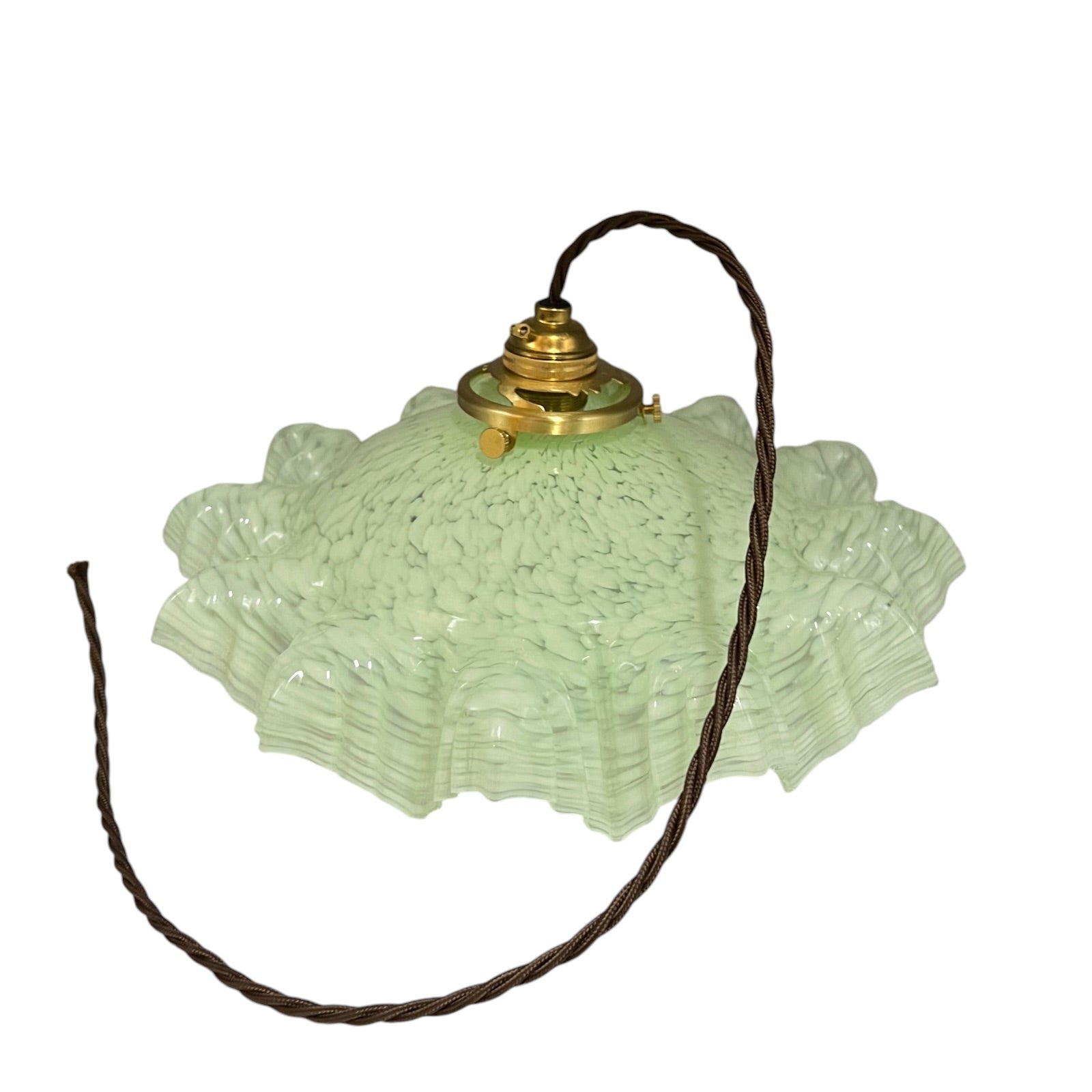 A vintage-style light fixture featuring a textured, ruffled light green glass shade with a brass metal top and a dark brown hanging cord, shown against a plain white background.