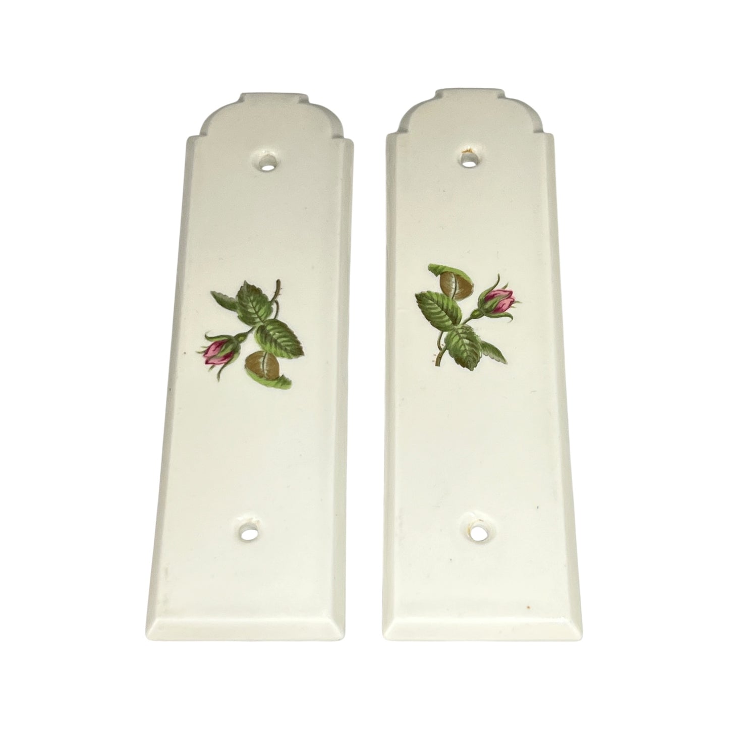 Pair of white door push plates with floral designs on a white background