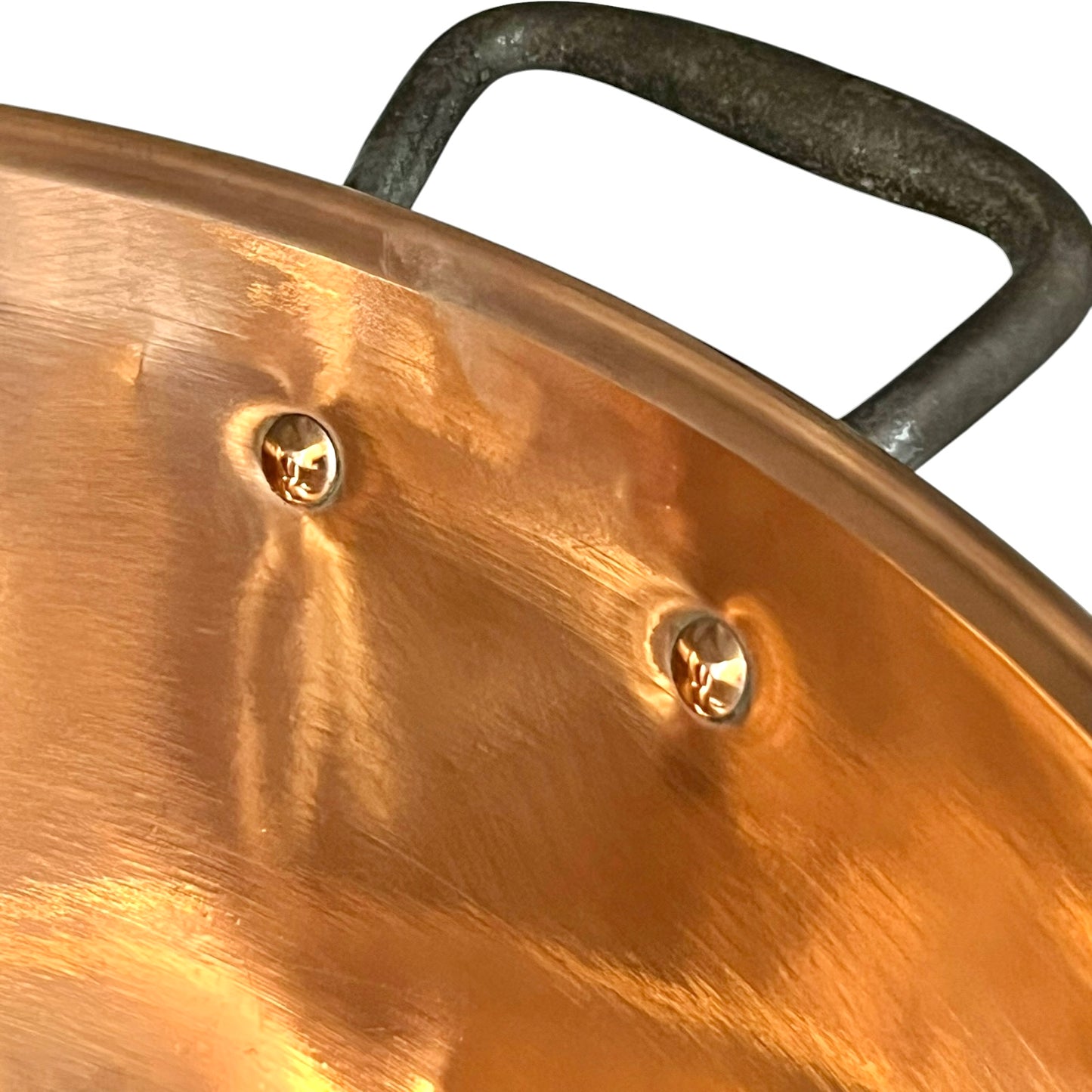 Close-up of a copper pot with a black handle on a white background
