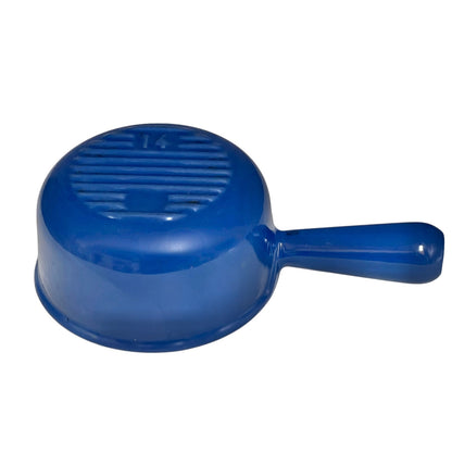 Blue cast iron Le Creuset pan with handle on a white background