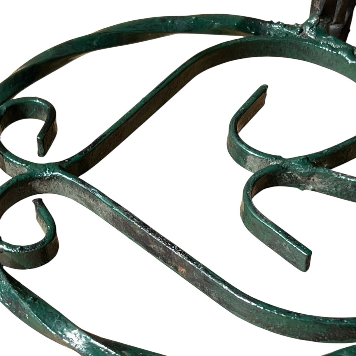 Close up of a wrought iron vintage plant stand on a white background 