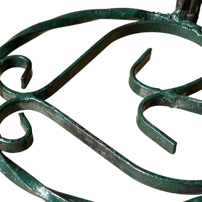 Close up of a wrought iron vintage plant stand on a white background 
