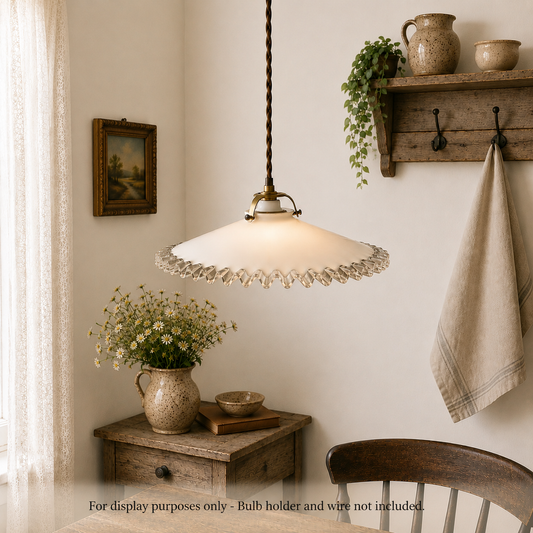 Vintage-style pendant light hanging in a room with wooden furniture and decor.