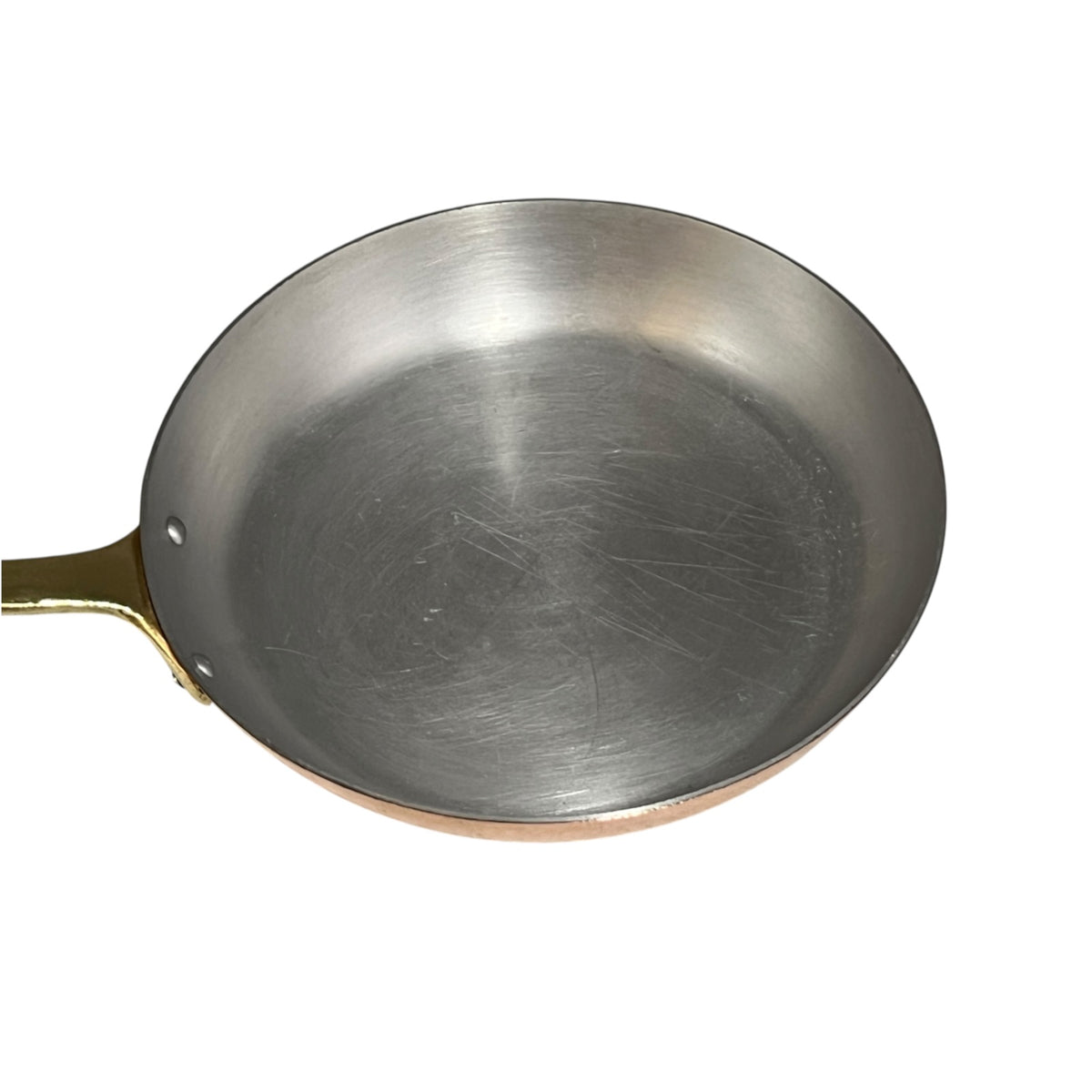 A aluminium lined frying pan with a copper exterior rim and a gold-toned handle, shown from a top-down angle on a white background.