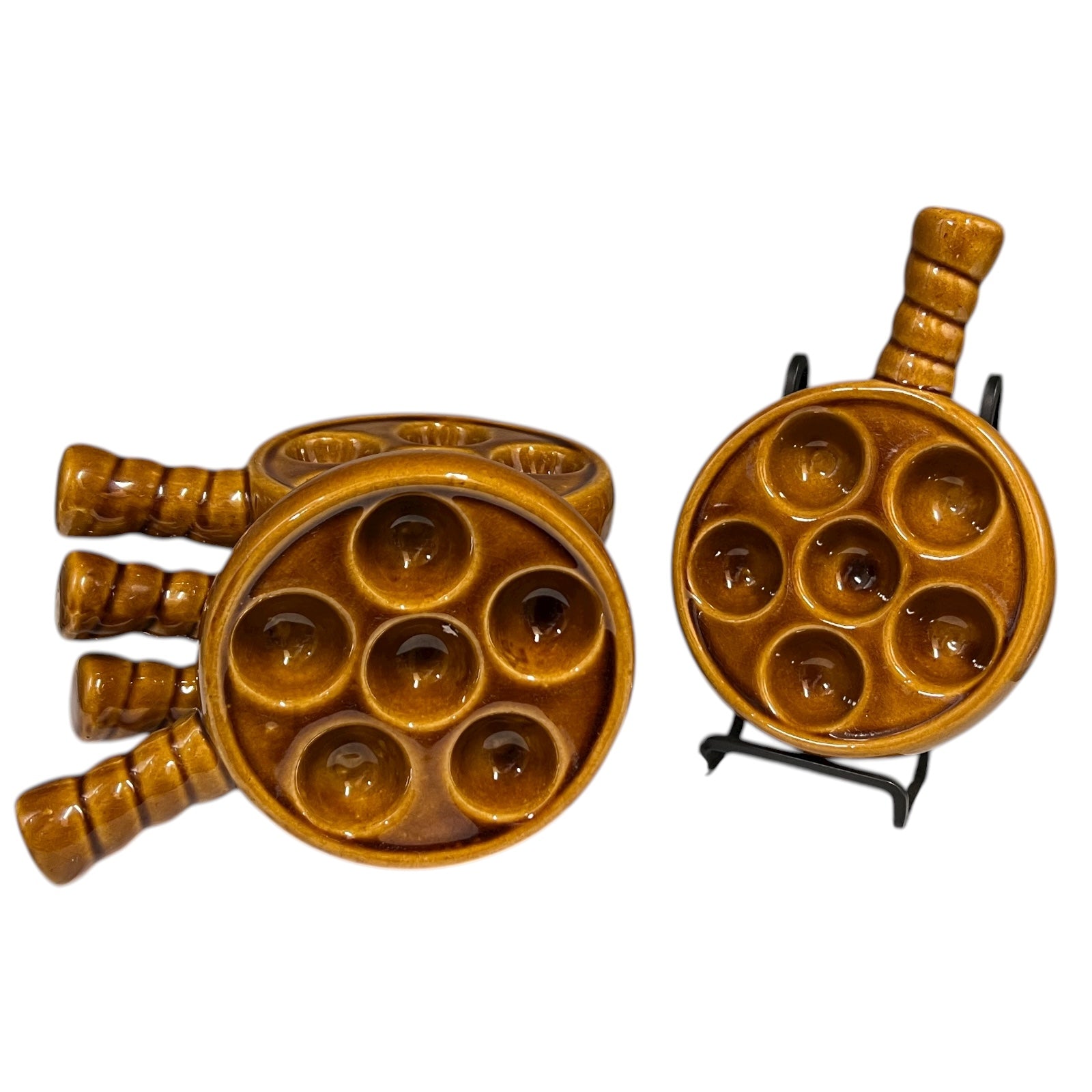 set of 5 amber brown coloured 6 hole snail plates on a white background 