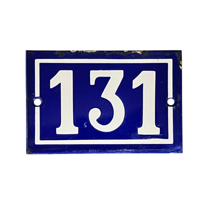 A rectangular blue house number plaque with white lettering reading '131' and a white border, shown on a plain white background.