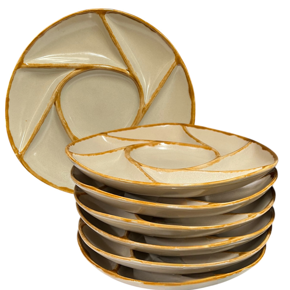 A set of ceramic divided plates with a swirled segment design, featuring a glossy cream-beige glaze and a rustic gold-brown rim, shown with one plate standing upright behind a stack of five on a white background.