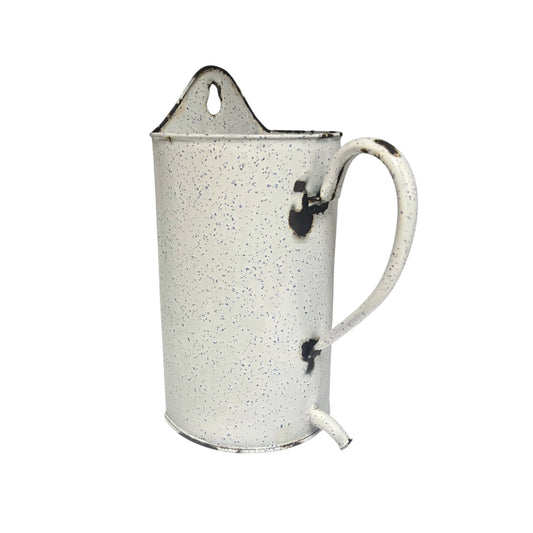 A vintage-style enamel metal pitcher with a speckled white and black finish, featuring a loop handle, a pouring spout, and a hanging loop at the top, shown against a plain white background.