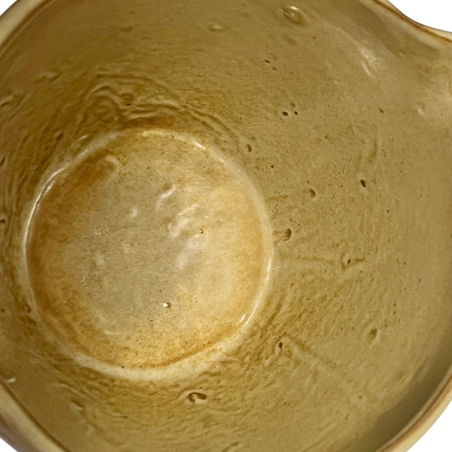 Close up of ceramic pitcher on a white background