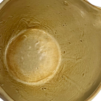 Close up of ceramic pitcher on a white background