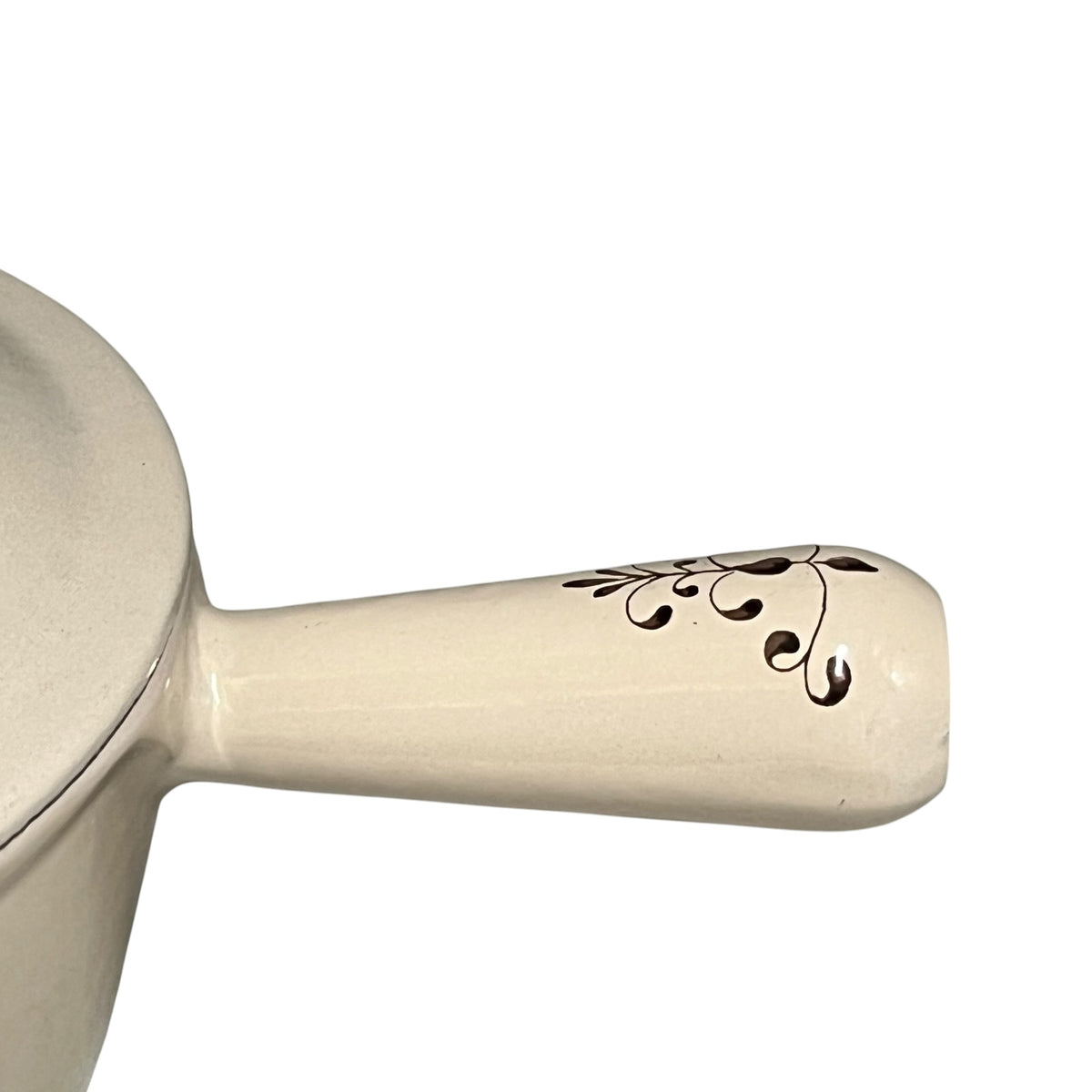 Close up of a Le Creuset pan handle showing the tulip pattern