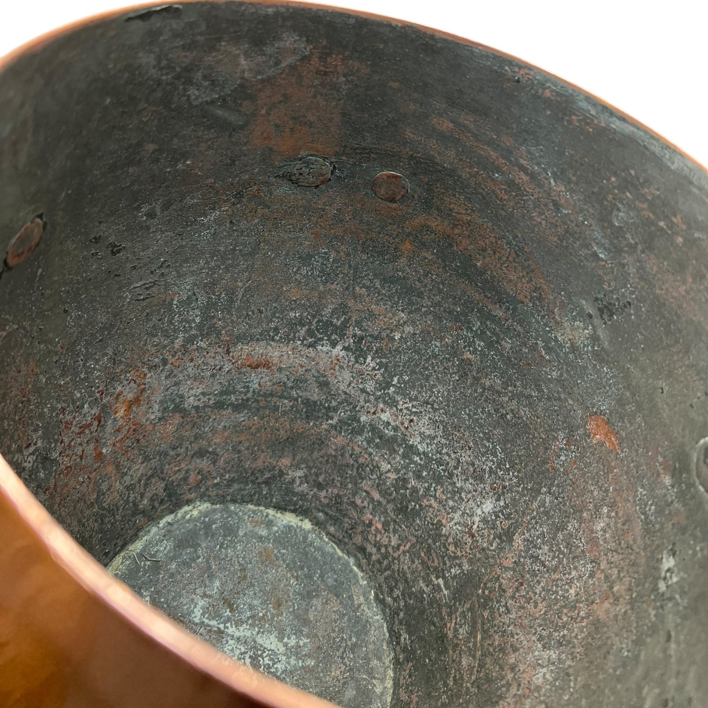Inside of a copper cooking pot stockpot with handles on a white background