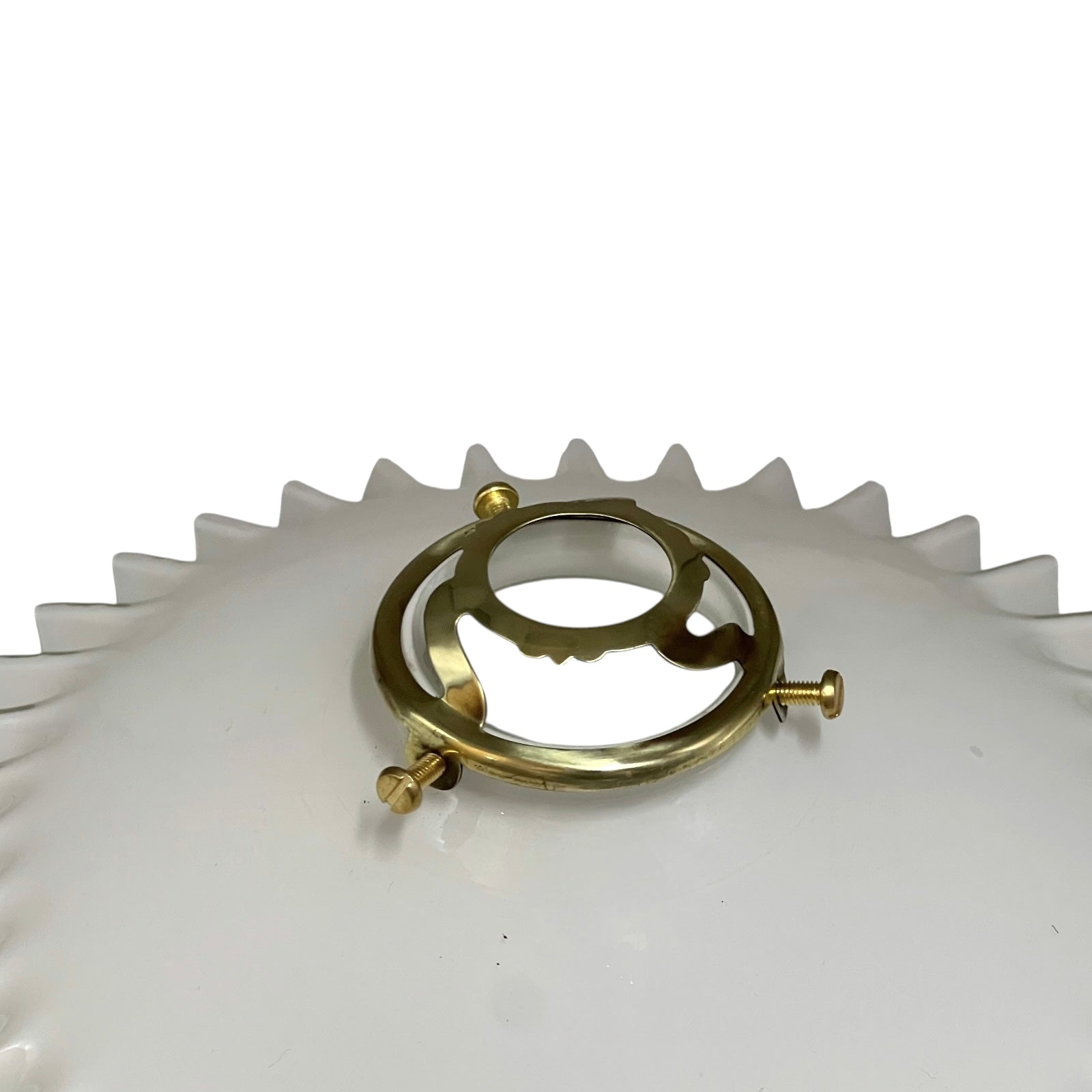 Gold circular object with screws on a white gear-like background