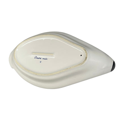 White ceramic dish with decorative text on a white background