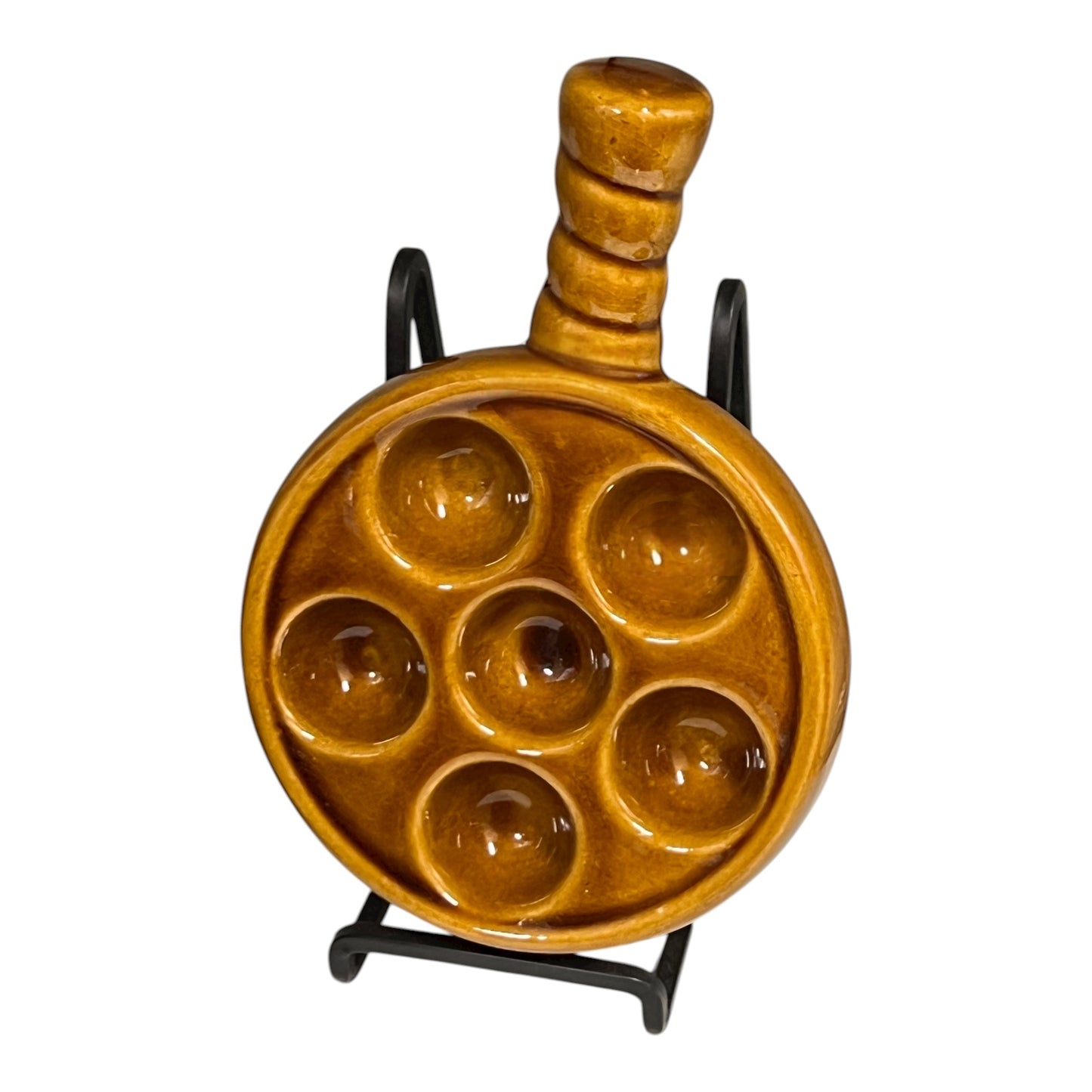  amber brown coloured 6 hole snail plate on a white background 