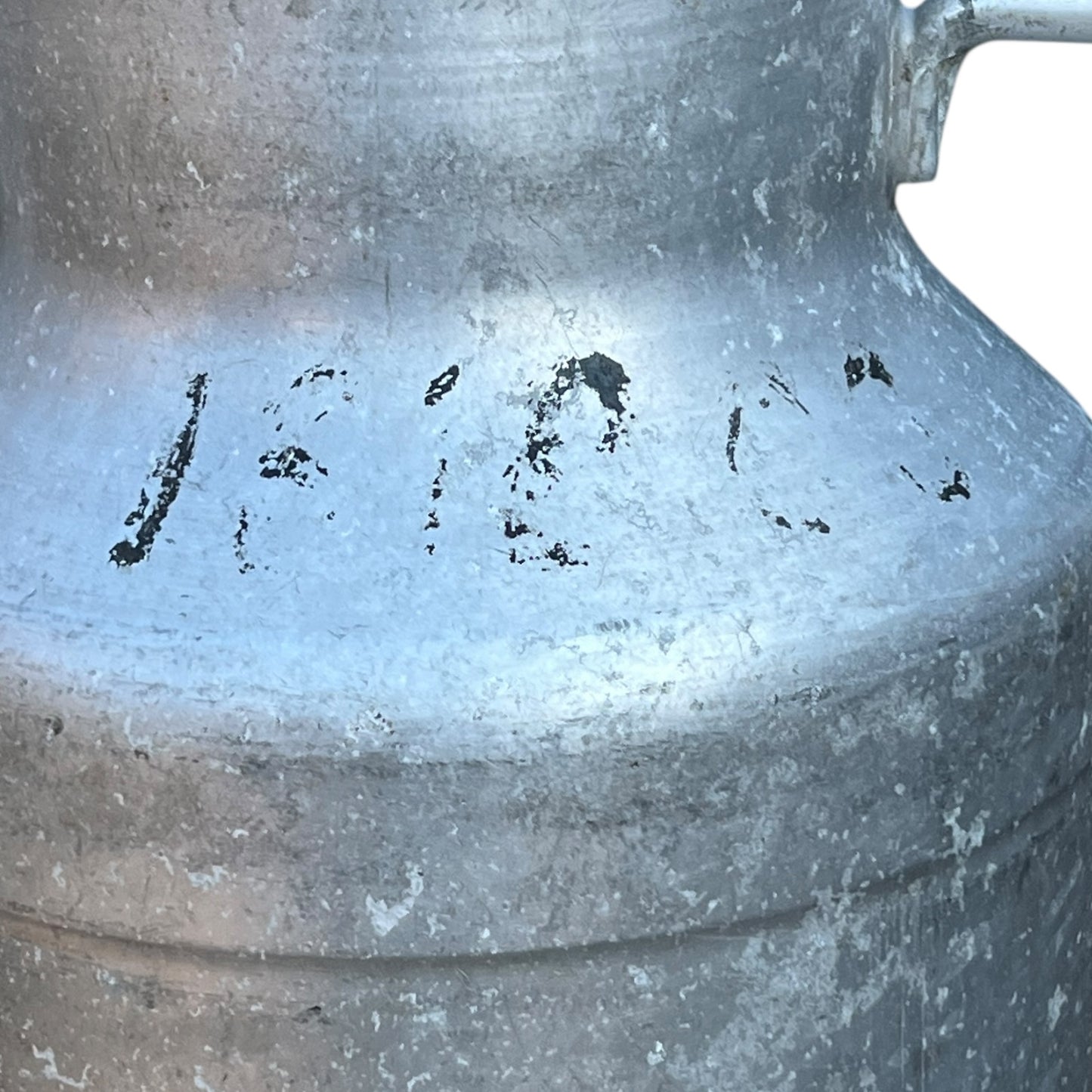 Close up of a Vintage French aluminium milk churn with a lid on a white background
