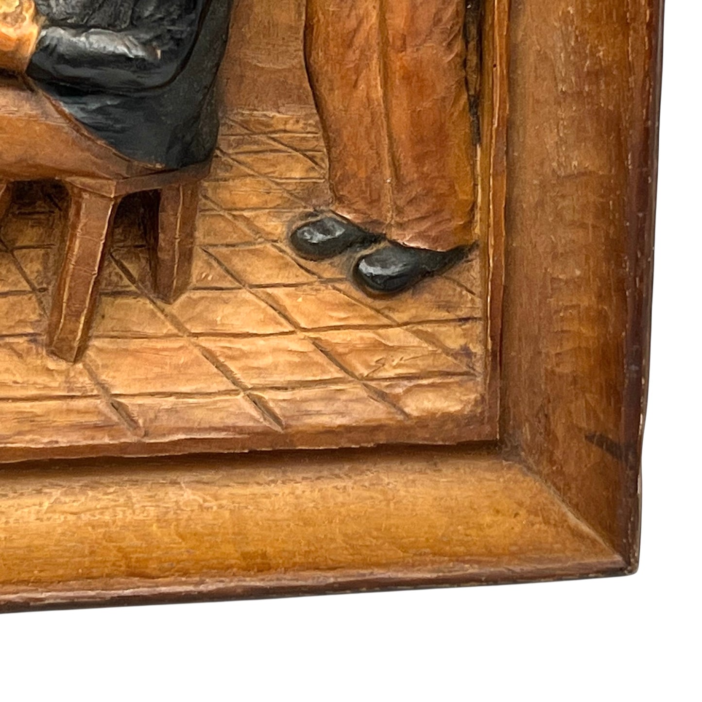 close up of wooden relief sculpture in an arts and crafts style on a white background