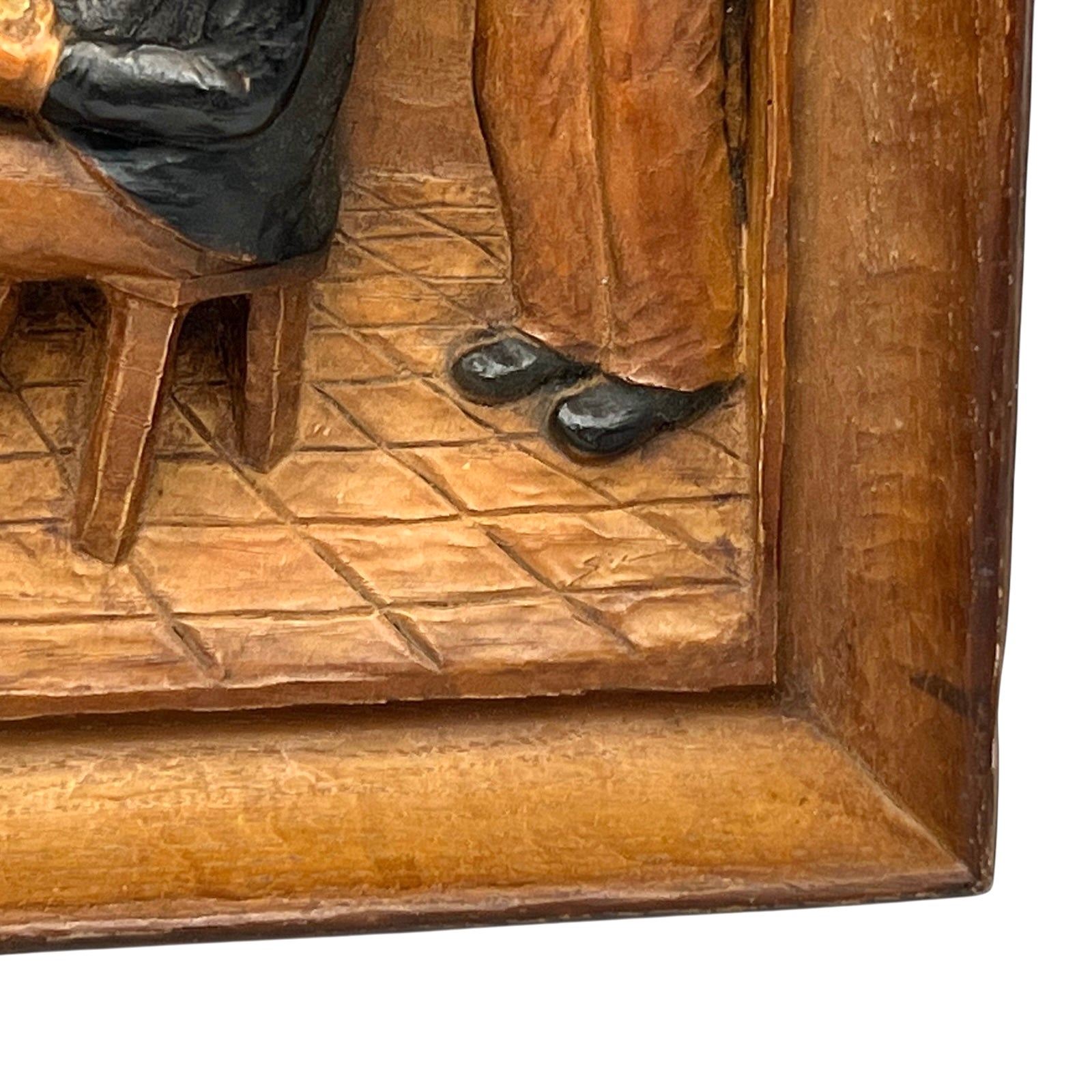 close up of wooden relief sculpture in an arts and crafts style on a white background