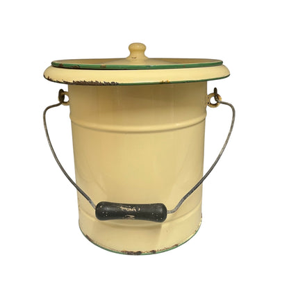A charming French vintage enamel lidded potty bucket with a wooden handle, featuring a cream finish accented by a green trim. Perfect for use in a farmhouse kitchen as a vegetable or bread bin, or repurposed as a unique garden planter, displayed against a crisp white background.