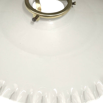Close-up of a white lampshade with a gold ring on a white background