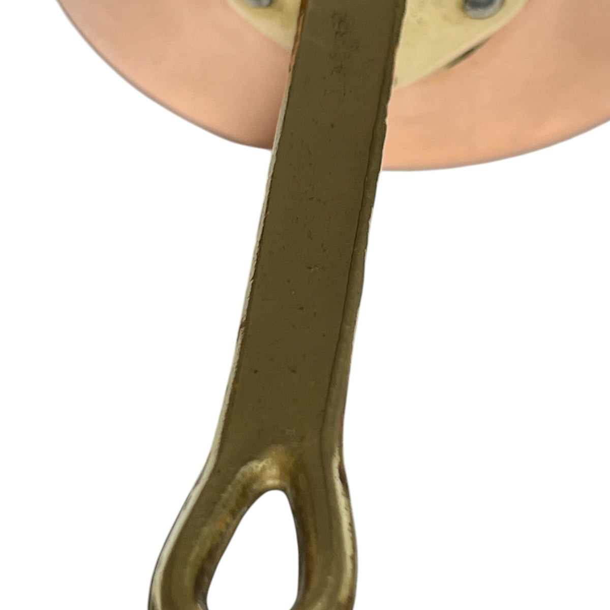 Close-up of a brass metal handle or bracket with a circular copper pan at the top, shown against a plain white background.