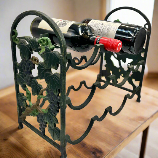 Decorative wine rack with a bottle of red wine on a wooden surface