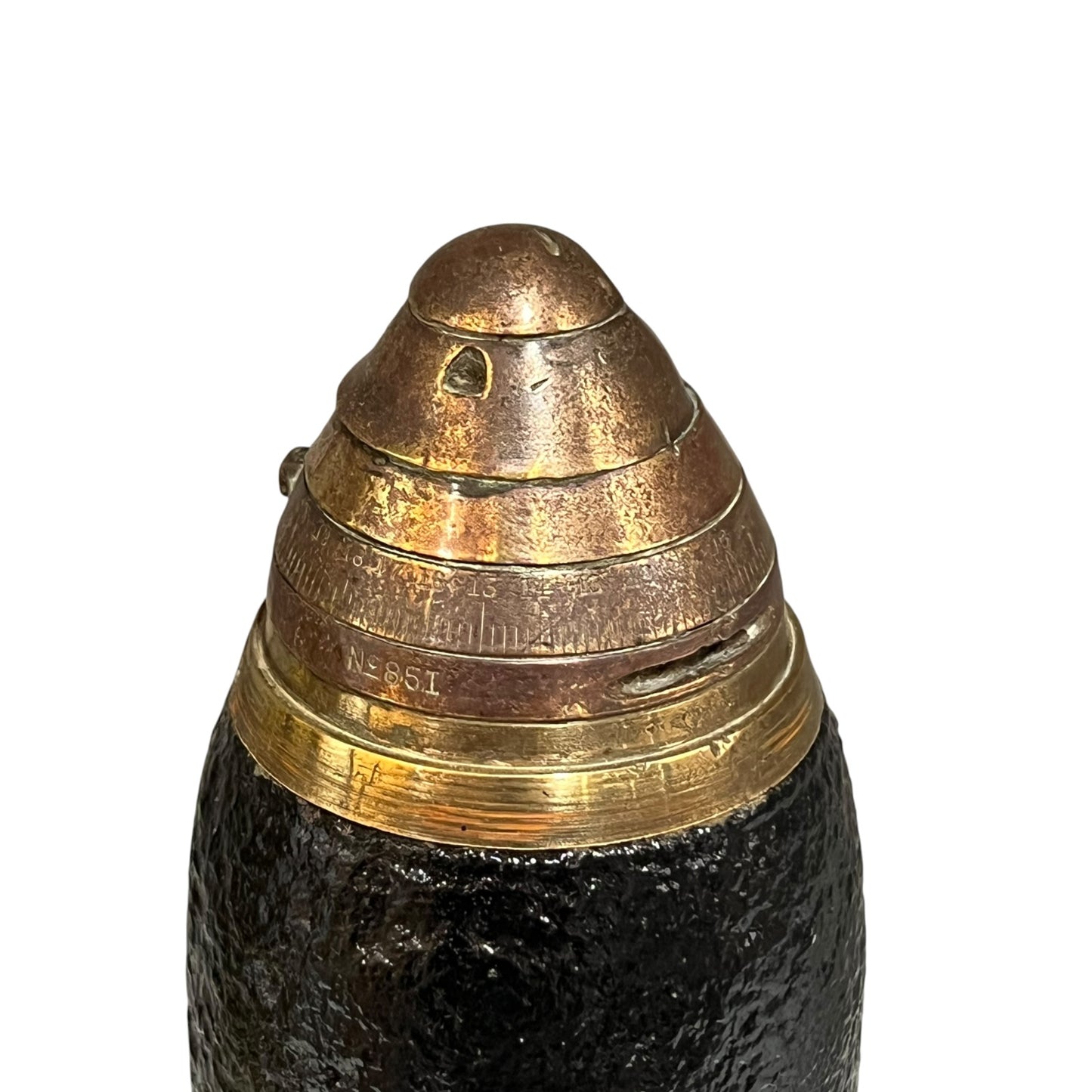 Close up of a British WW1 brass fuse on a black shrapnel shell st on a white background 
