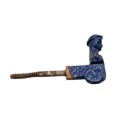 French cast iron shutter dog painted blue with signs and age and wear on a white background