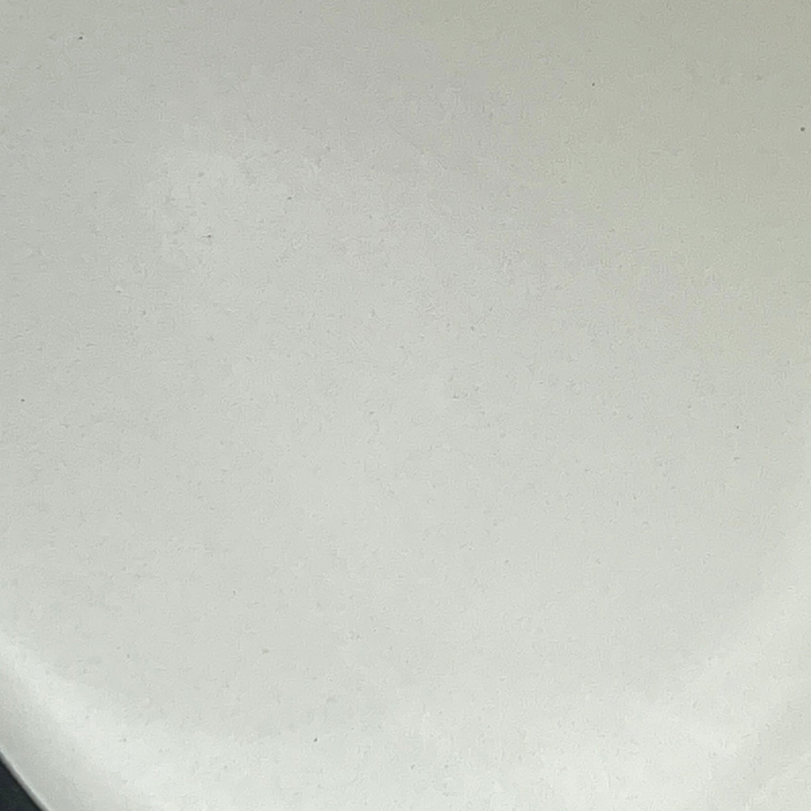 Green frying pan with a white interior on a white background