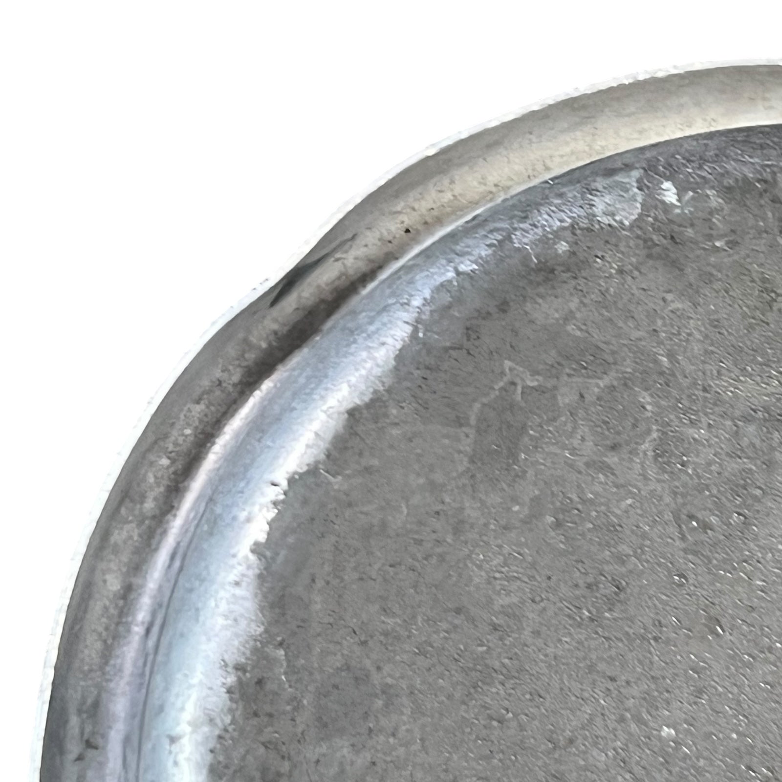 close up of metal milk churn on a white background