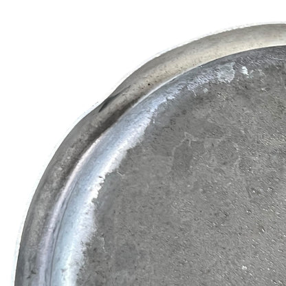 close up of metal milk churn on a white background