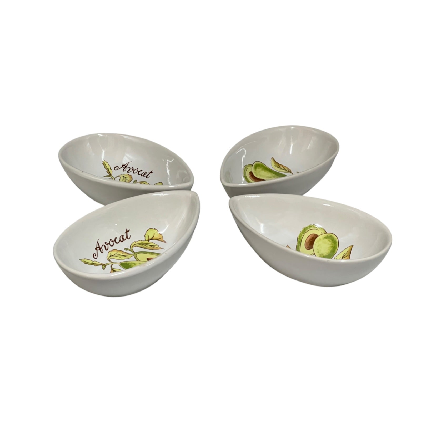 Four white ceramic avocado-themed serving bowls arranged in a square on a white background, each decorated with illustrations of avocado slices and the word 'Avocado'.