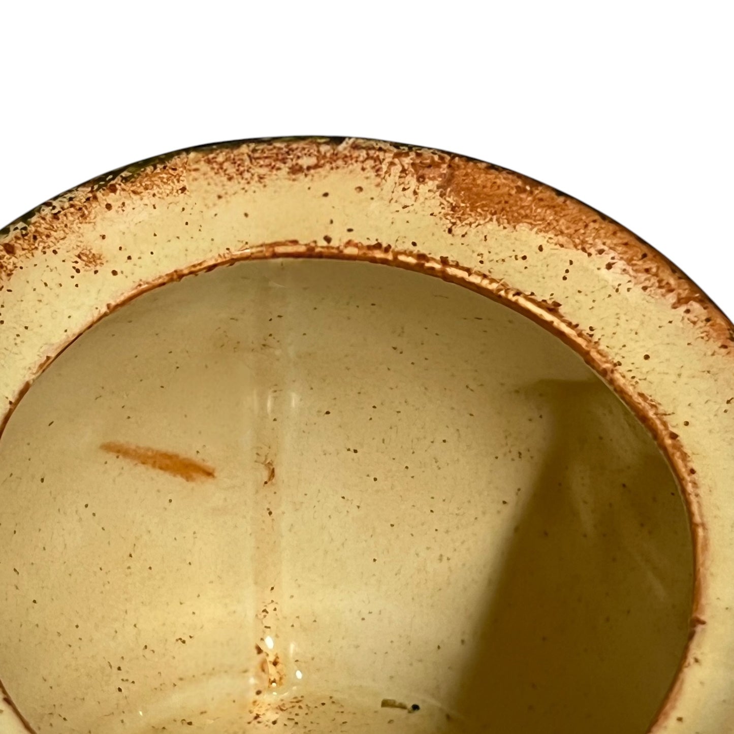 Close-up of a ceramic jar with embossed design on a white background