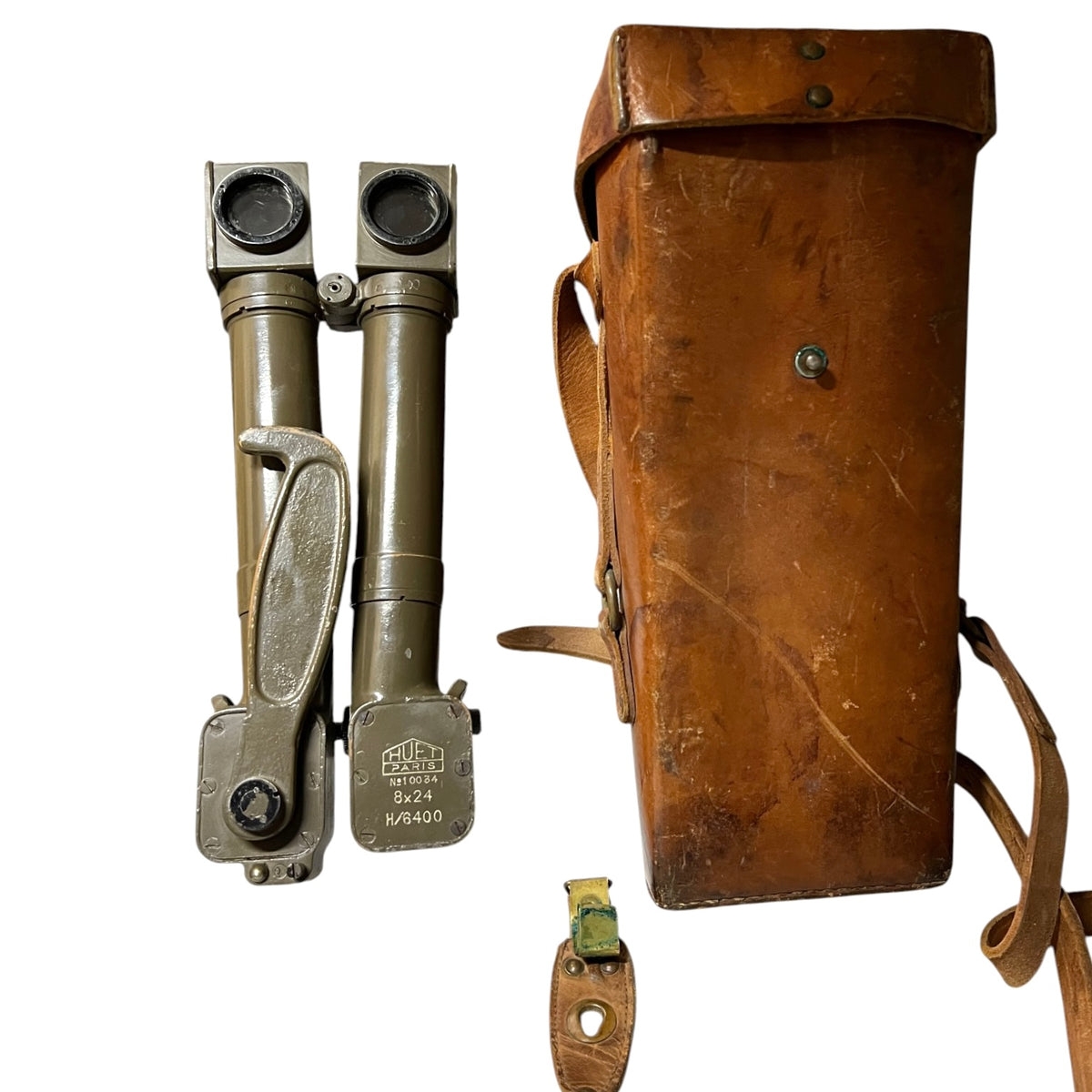 Vintage military binoculars in olive green metal with a brown leather case and matching leather strap, shown on a plain white background.