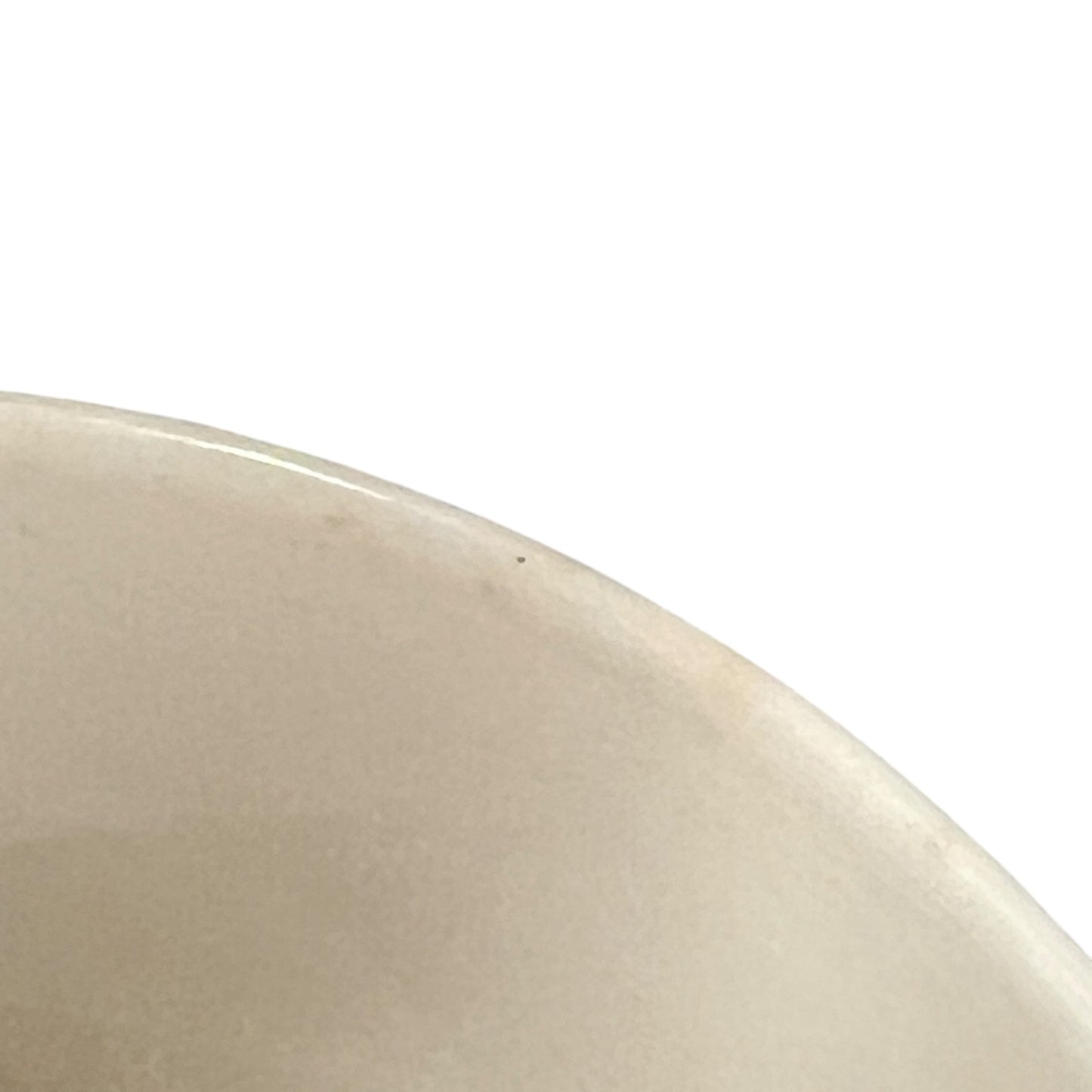 Close-up of a beige ceramic plate on a white background