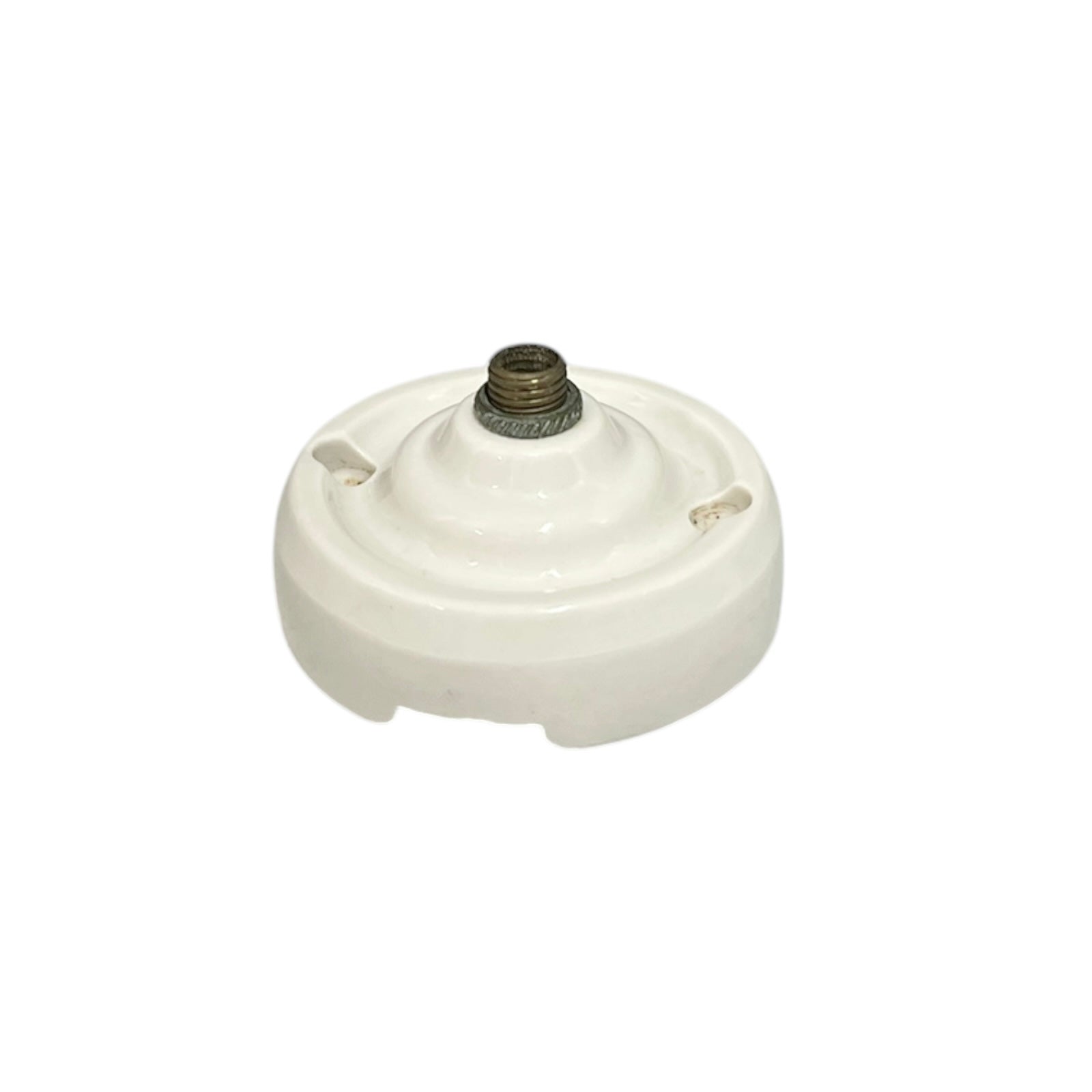 Small vintage French porcelain ceiling rose with a brass nut on a white background 