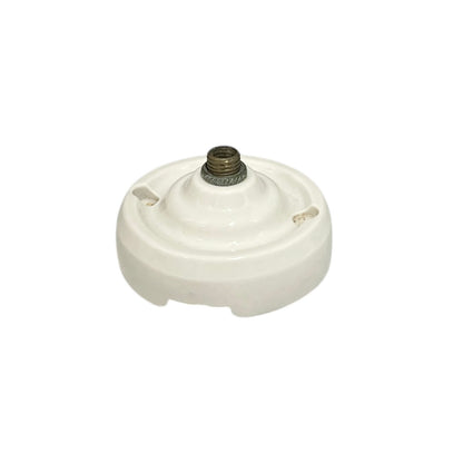 Small vintage French porcelain ceiling rose with a brass nut on a white background 
