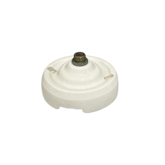 Small vintage French porcelain ceiling rose with a brass nut on a white background 