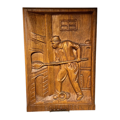 Wooden plaque with a carved scene of a man holding a club, on a white background