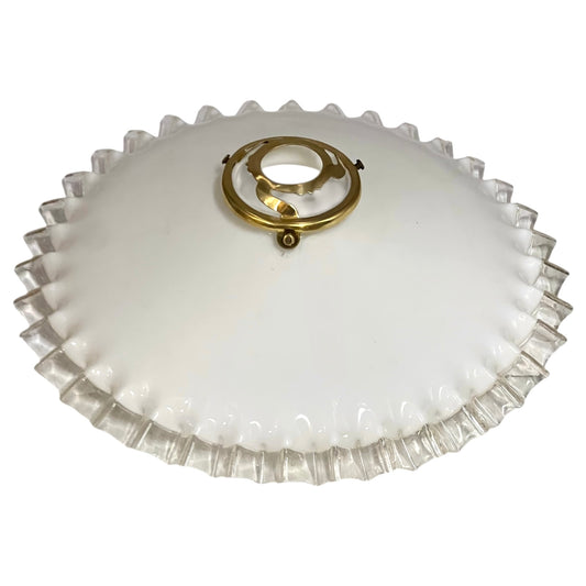 Vintage glass lampshade with ruffled edge and gold fixture on a white background