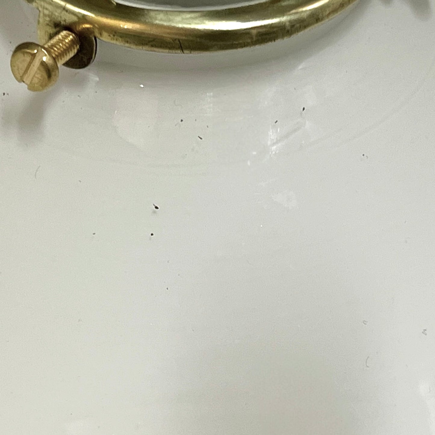 Close-up of a brass screw on a white surface