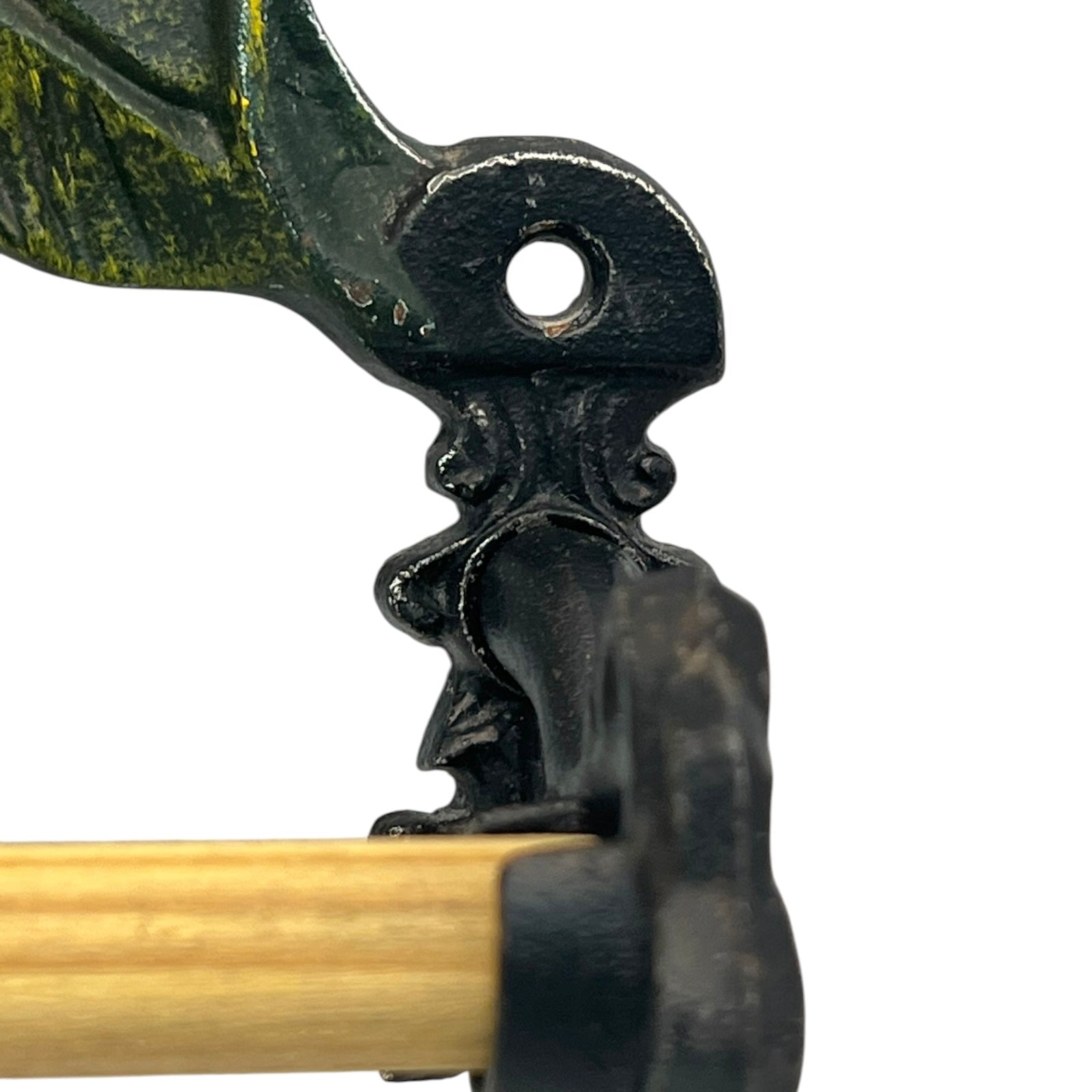 close up of a cast iron kitchen roll holder on a white background 