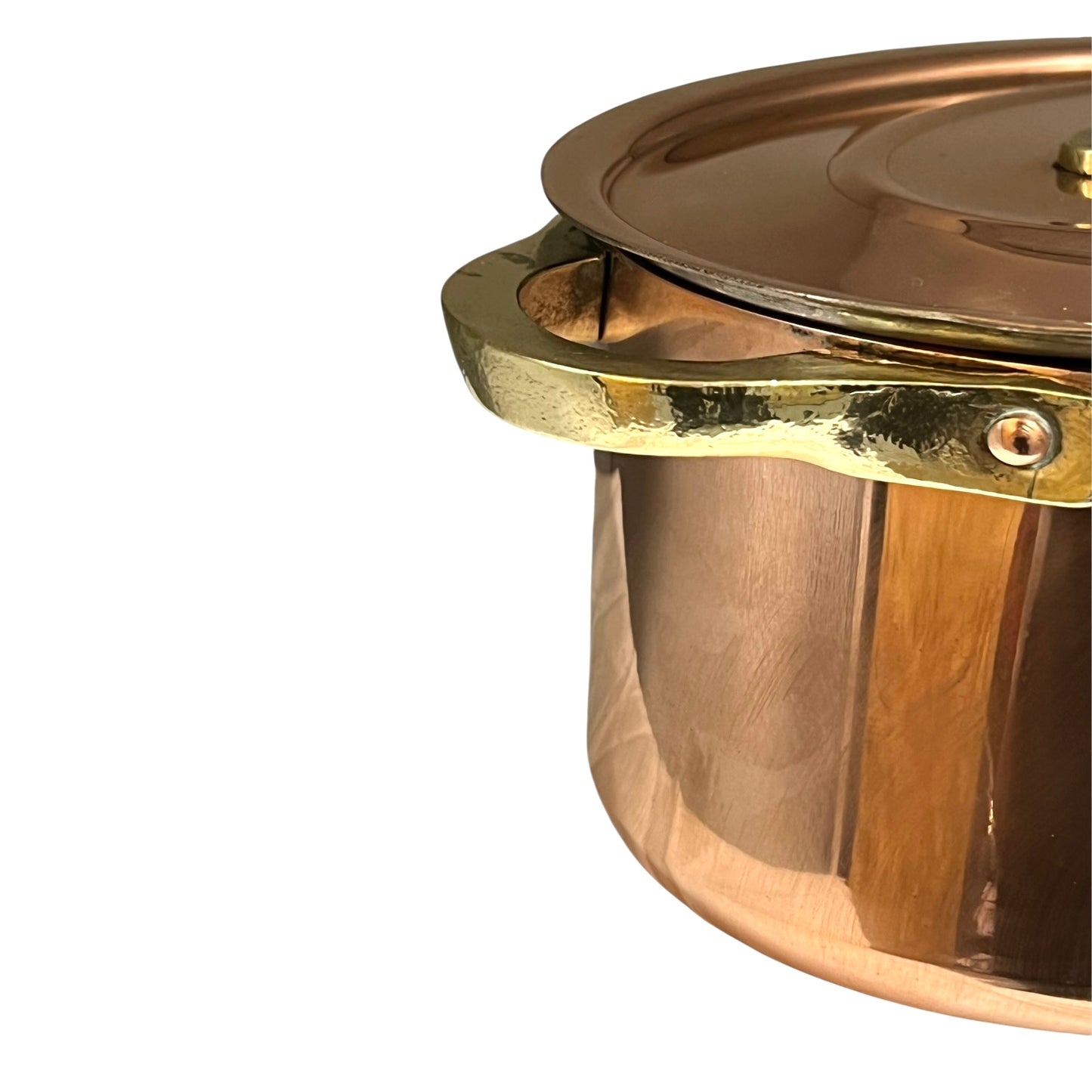 Close-up of a copper lid with a handle on a copper casserole pot