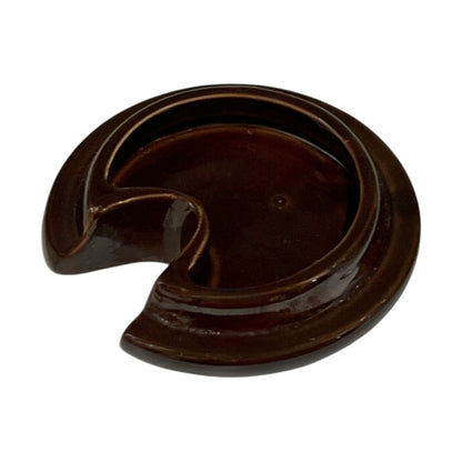 Dark brown ceramic lid on a white background