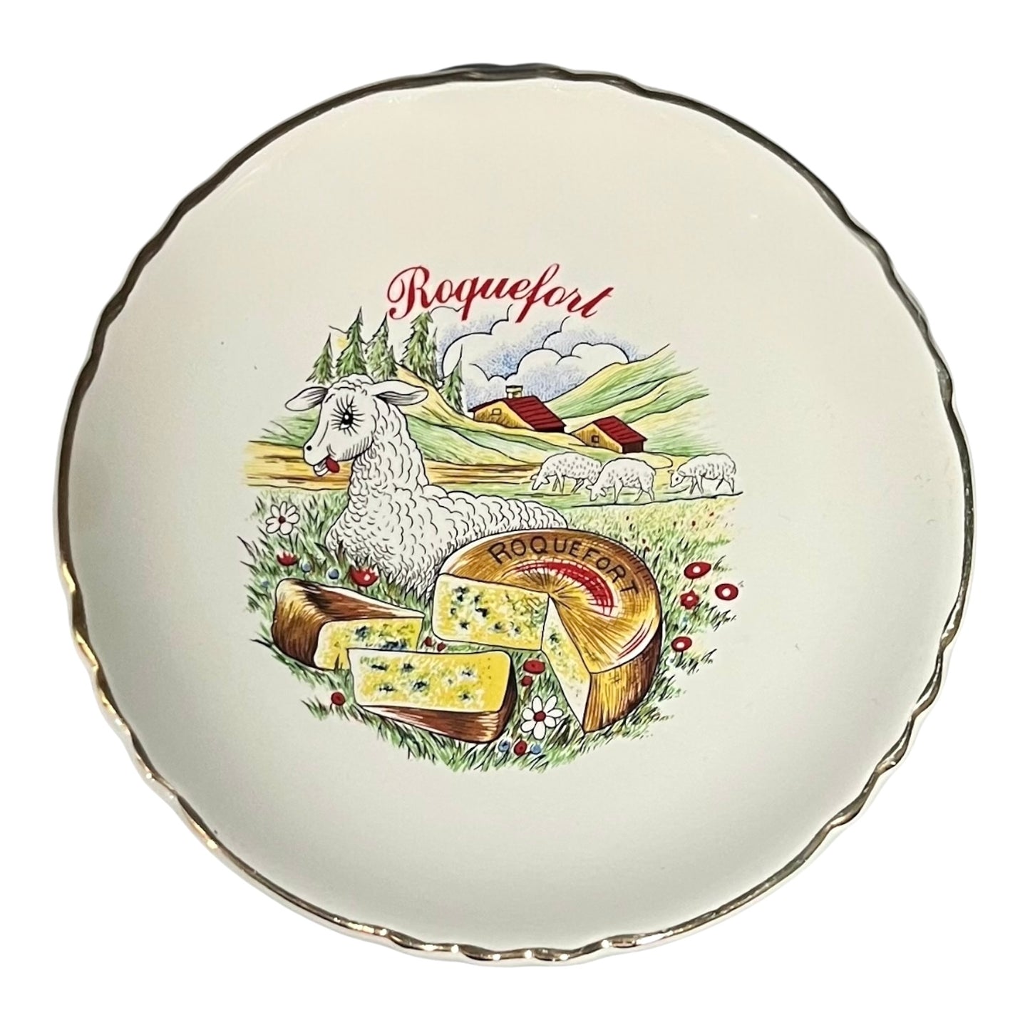 Decorative plate with a goat, cheese, and landscape design on a white background